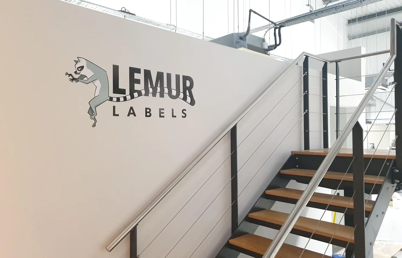The Lemur Labels factory in Hyde — logo on the mezzanine wall